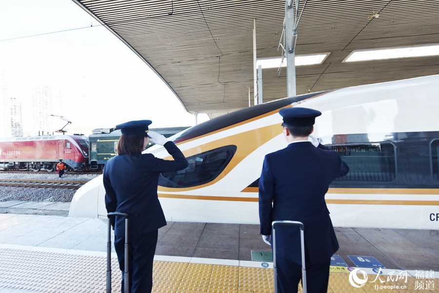 劉純與師傅劉斌敬禮接車。 余杉芳攝
