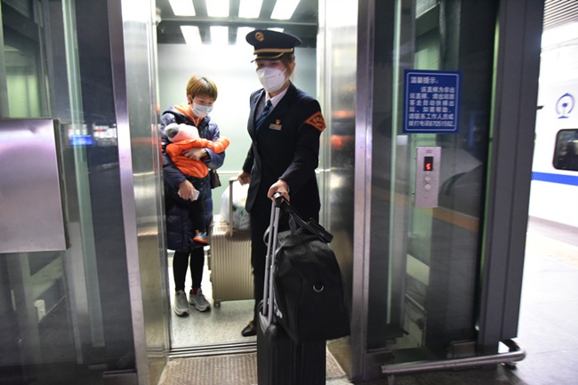福州火車站值班站長趙靜護送曹女士乘坐電梯。江曲攝
