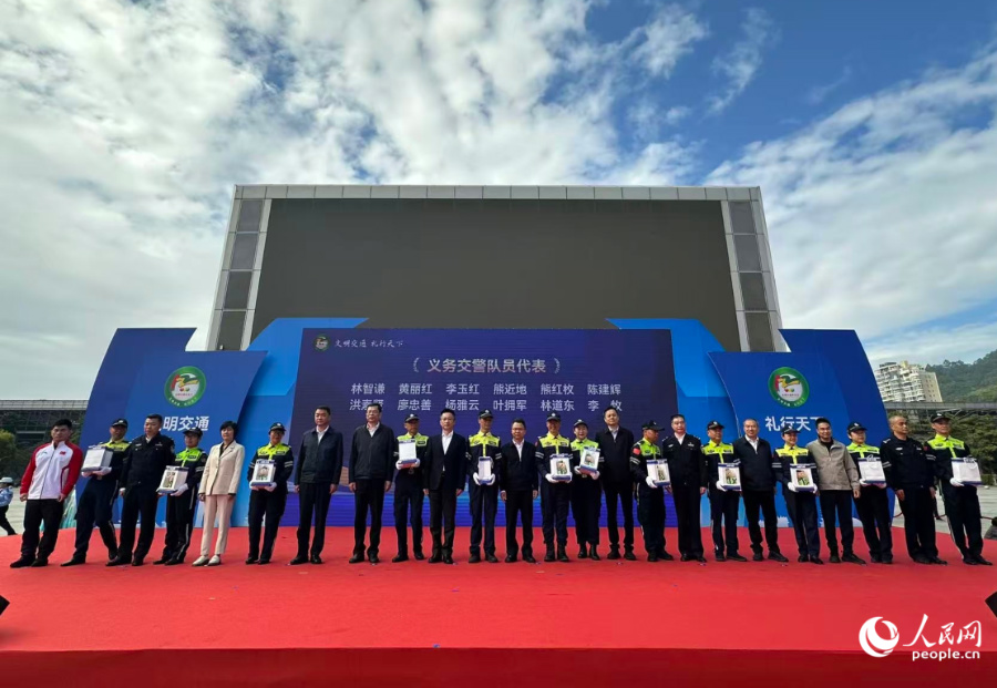 为义务交警代表颁发纪念品。人民网记者 张萌摄