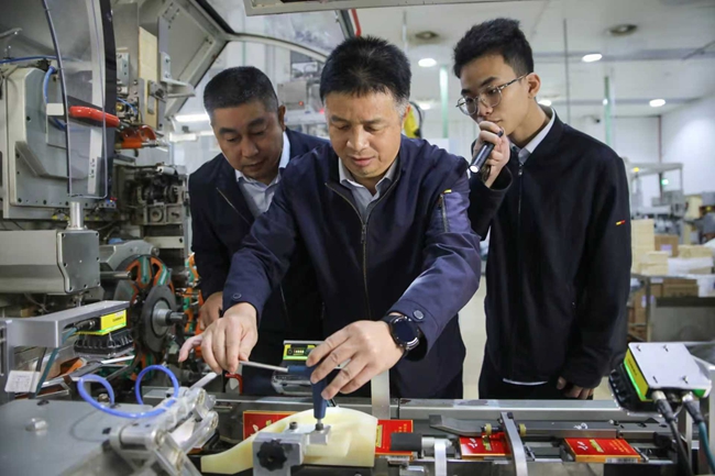 首席技师郑东文带领团队成员调试设备