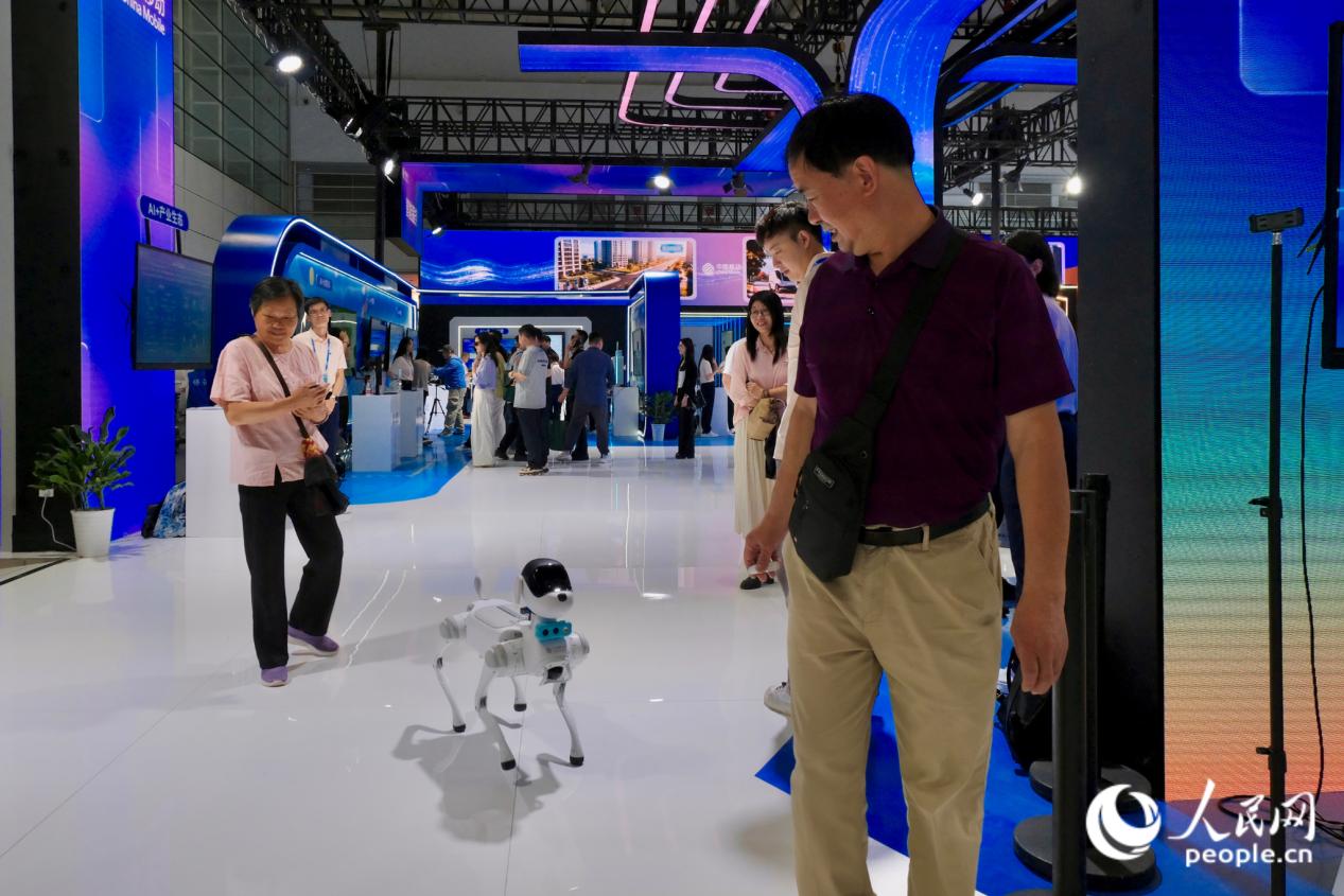 观众体验无绳“溜”机器狗，一路上吸睛无数。人民网 欧阳奕奕摄