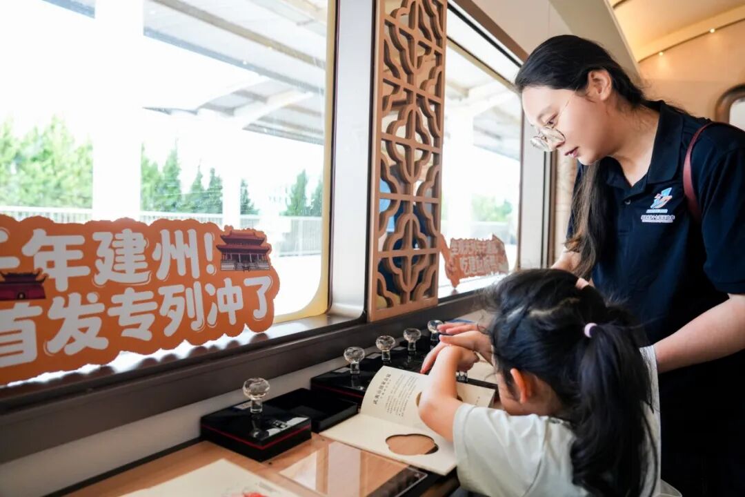 游客在列车上体验建本拓印等非遗。