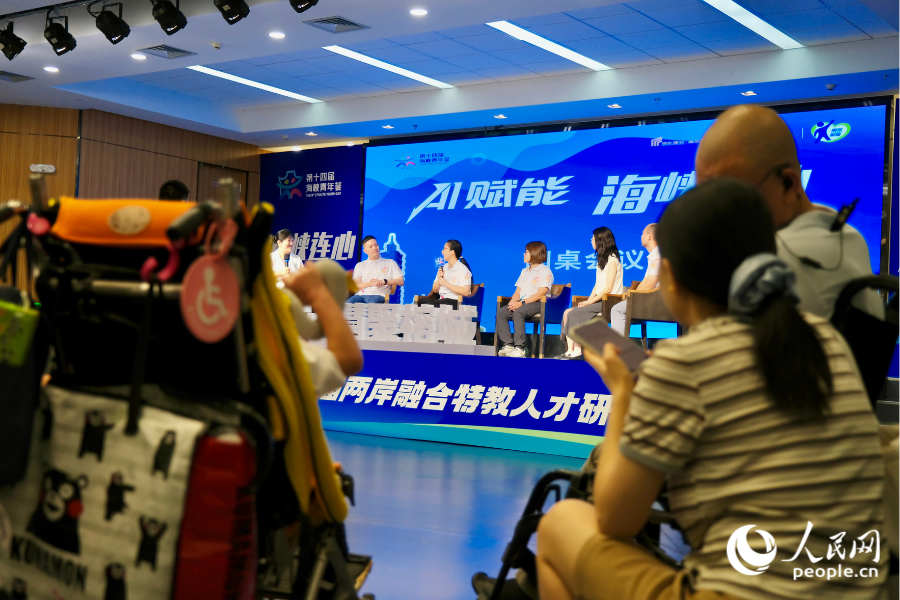 特殊儿童跟随家人坐在观众席里听专家分享。人民网 欧阳奕奕摄