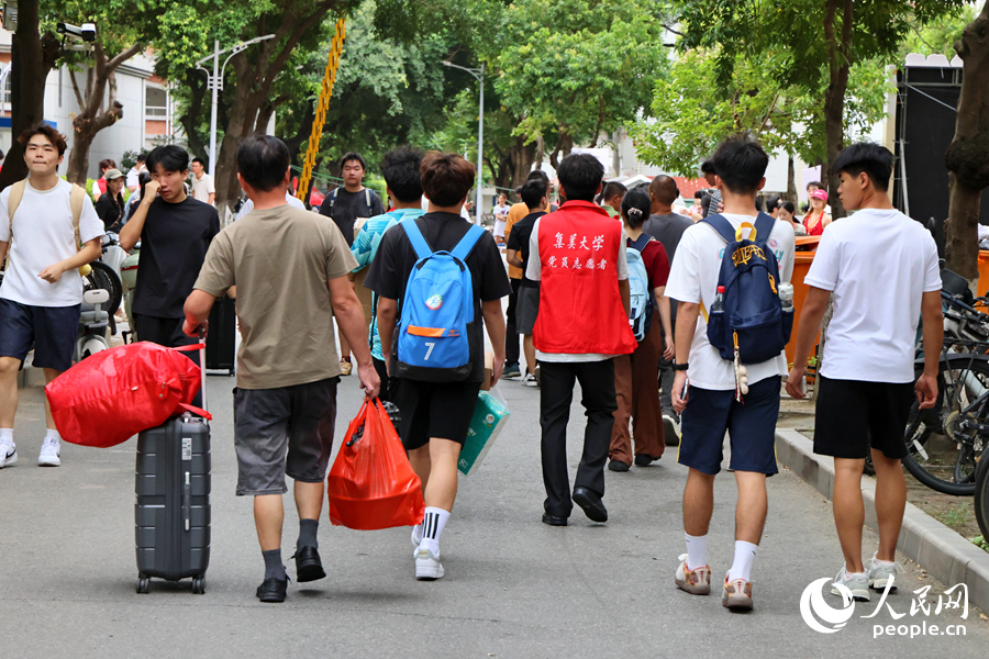 新生们提着行李漫步于校园林荫道。人民网记者 陈博摄
